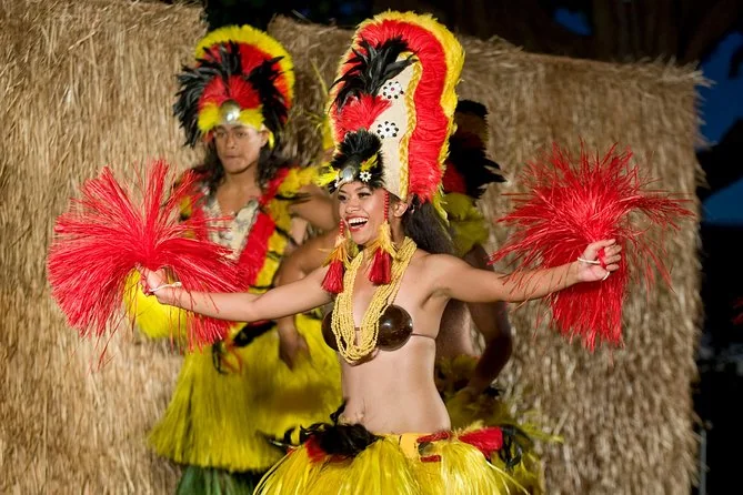 Dancers in red and yellow feathered Tahitian costumes